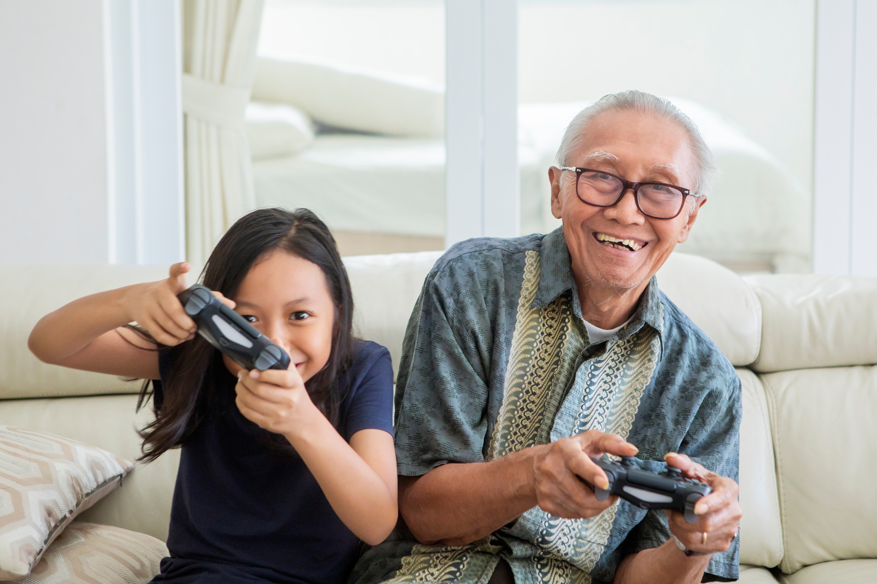 Cheerful Child Playing Video Games with Grandfather