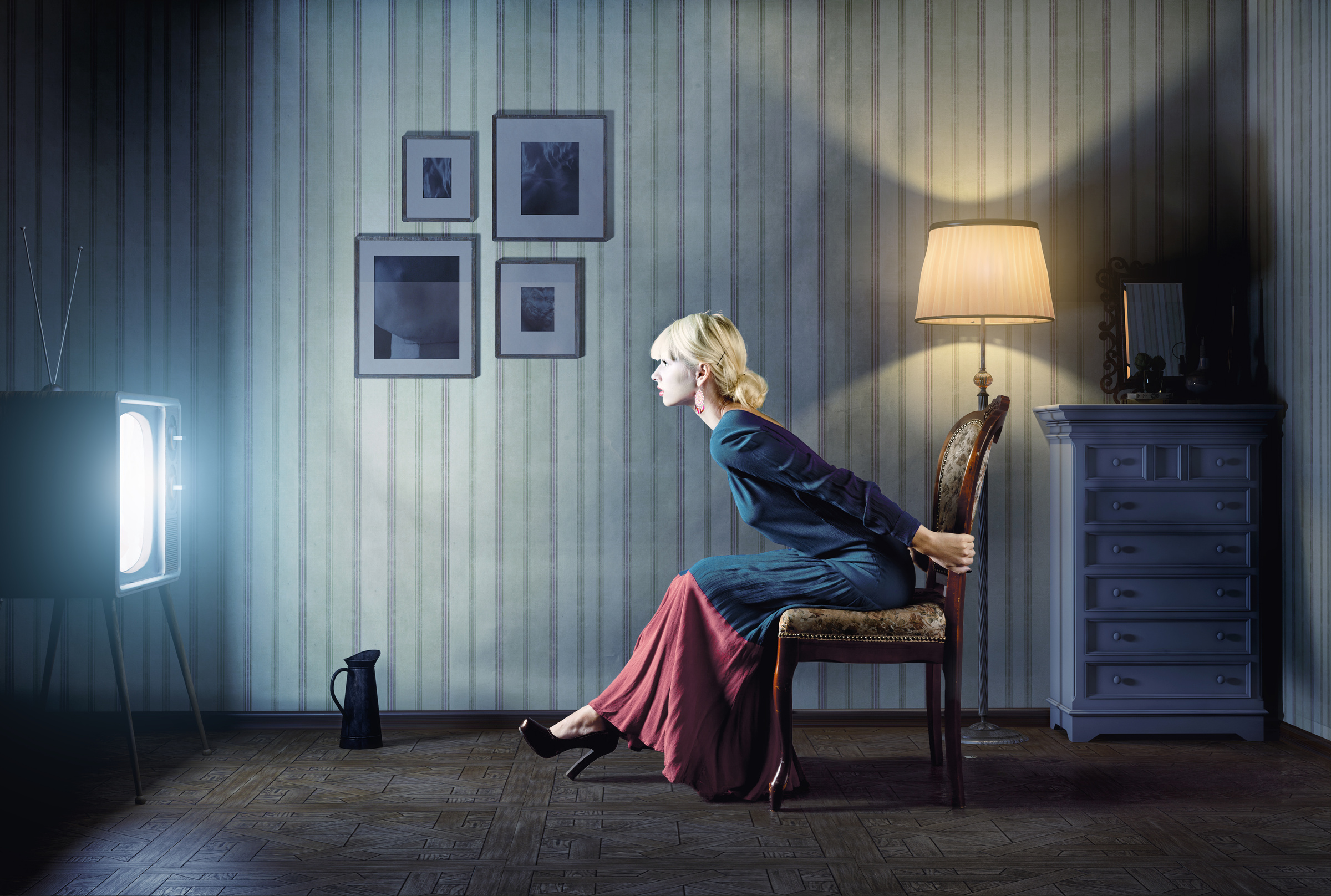 Woman watching TV in blue dress